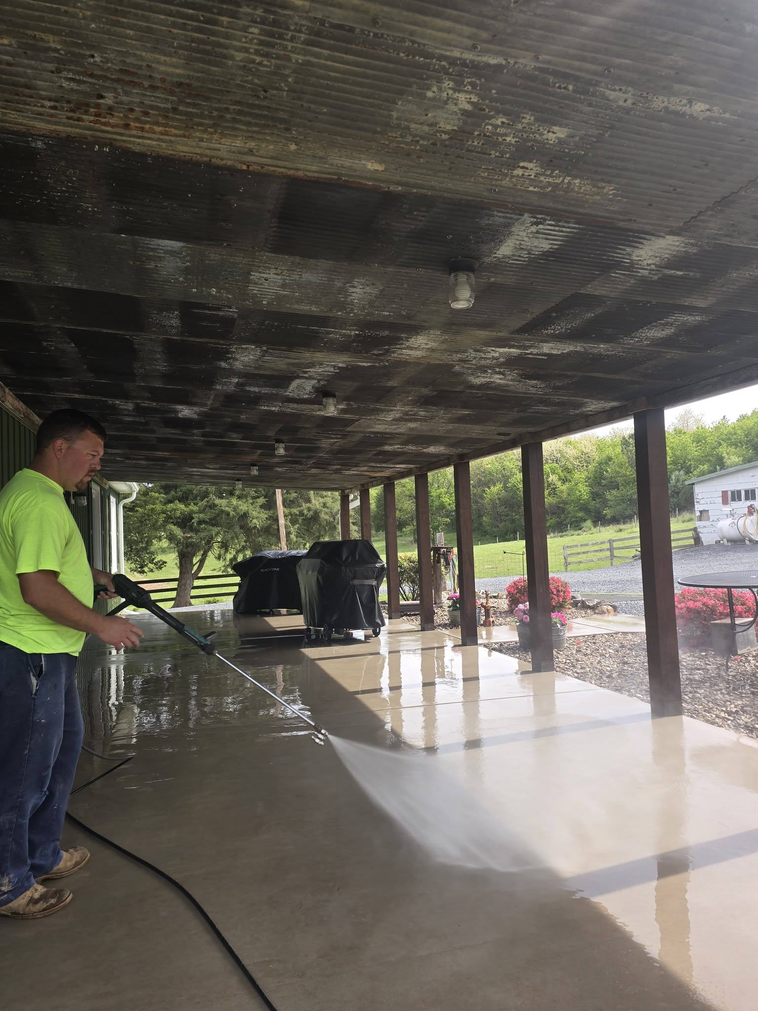 K.D. SHIPE technician pressure washing a home's exterior