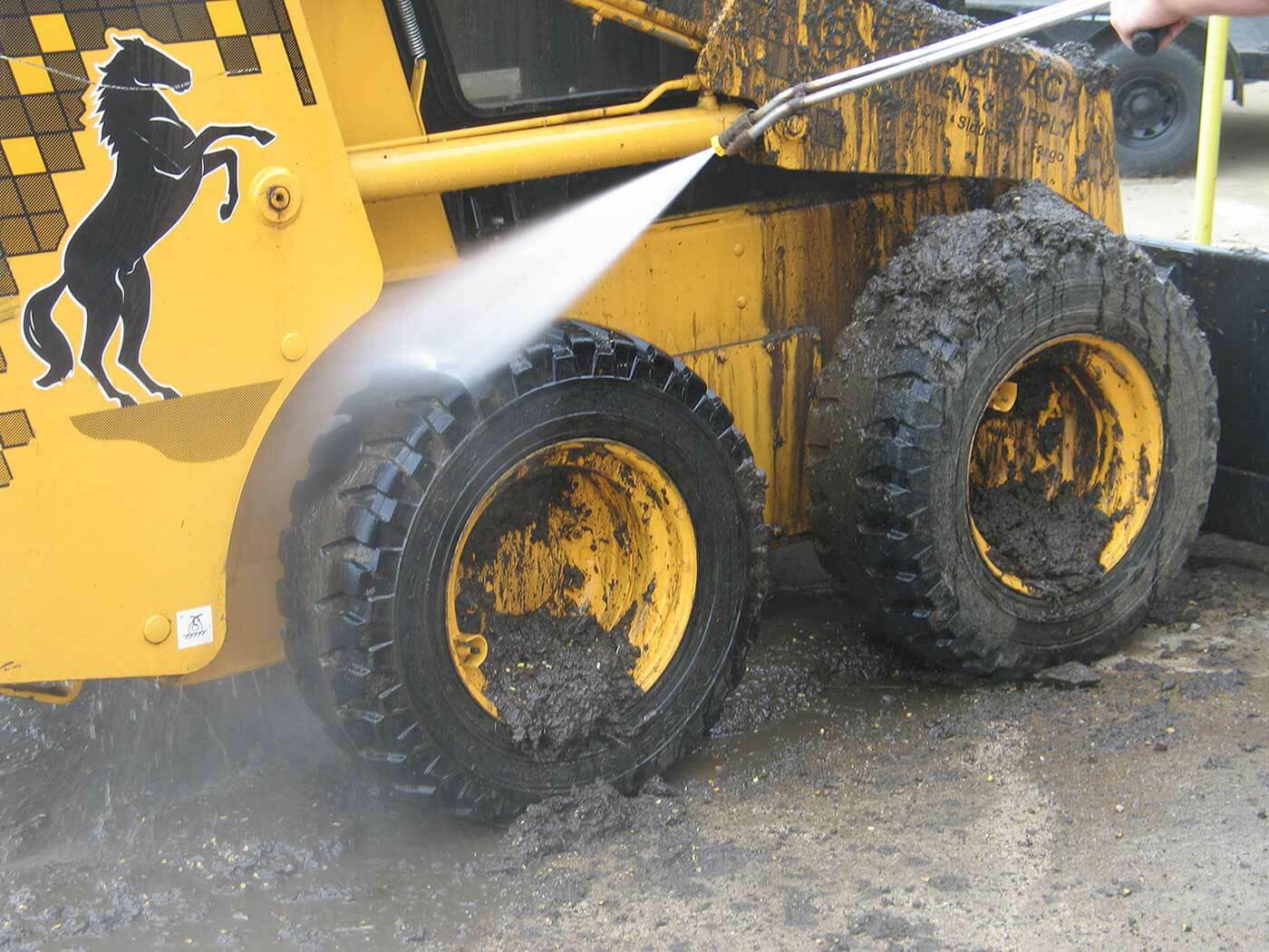 Pressure washing heavy equipment and commercial vehicles